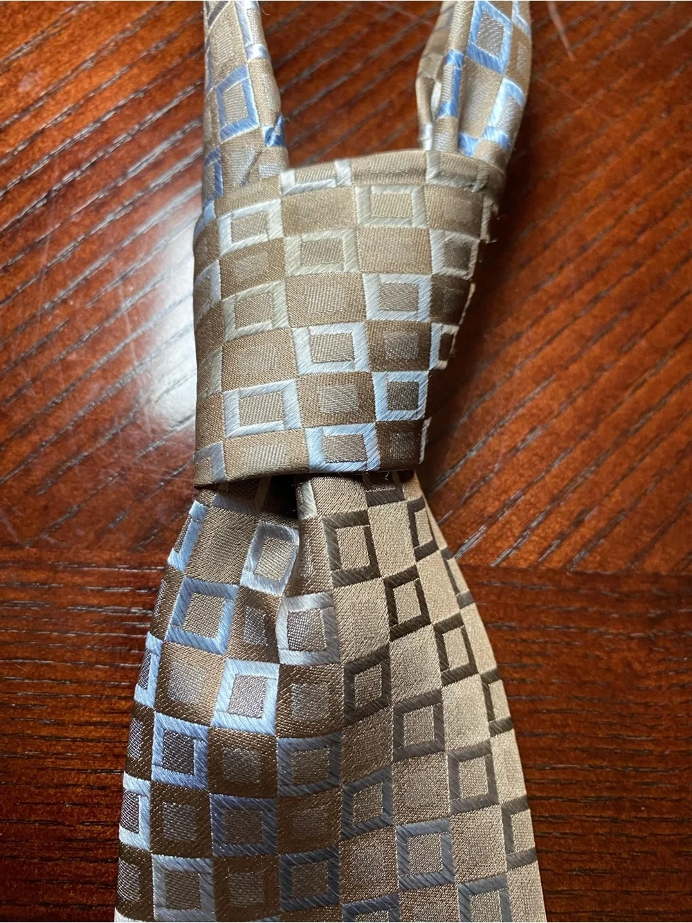 Men’s neck tie by Murano in light brown with a hint of blue & gray small squares